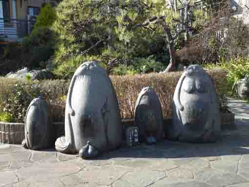 stone statues of a family of tanukis